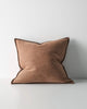 Brown cushion with a textural fabric and stitching detail on a white background