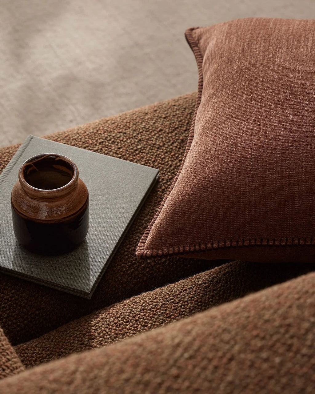 Brown interior close up featuring a textural cushion by Weave Home