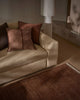 Beige sofa with brown cushions, by Weave Home, in a living room setting