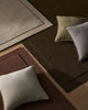 Three beautiful NZ wool rugs called 'Cassio' in beige, burgundy and chocolate brown with stylish cushions on top