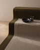 Two NZ wool rugs by Weave laid out on stairs with a ornaments