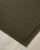 Close up corner of the Cassio Jasper NZ wool floor rug in a deep olive shade 