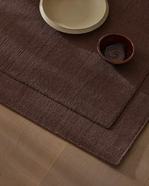 A burgundy NZ wool rug with frame feature by Weave Home