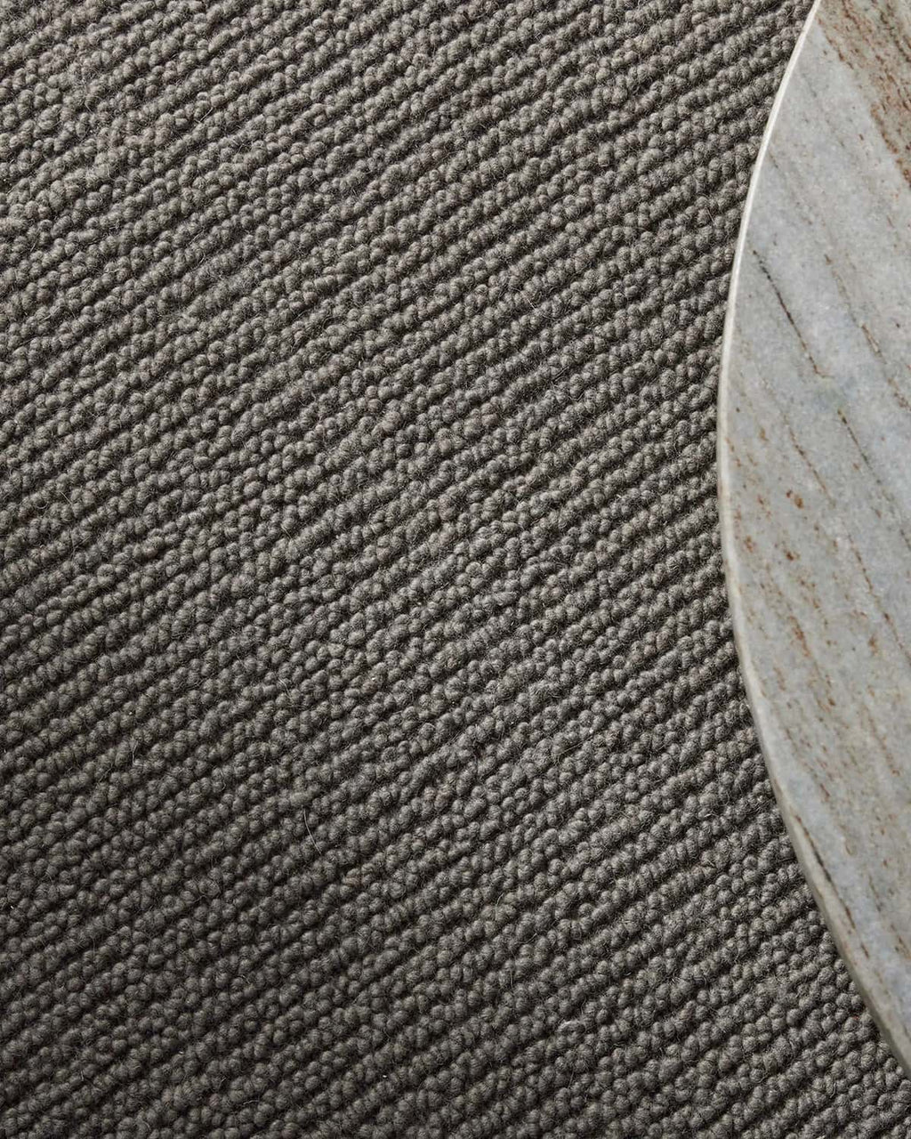 Close-up of a textured gray carpet corner
