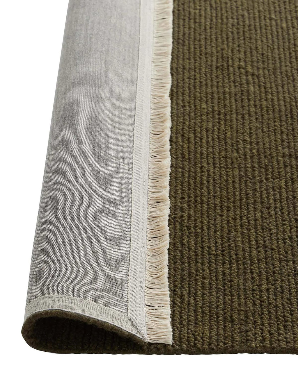 Close-up of a textured rug with a white border and green surface, the corner turned up to show the underside.