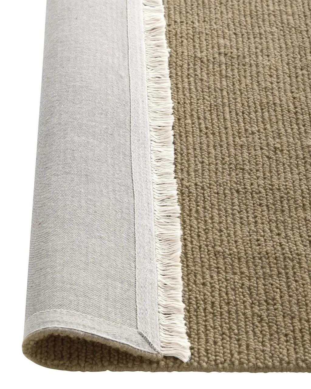 Close-up of a brown textured rug with a fringed edge, flipped up to show the underside, on a white background