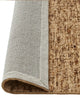 A modern floor rug by Weave Home nz, in shades of brown, rolled to reveal underneath