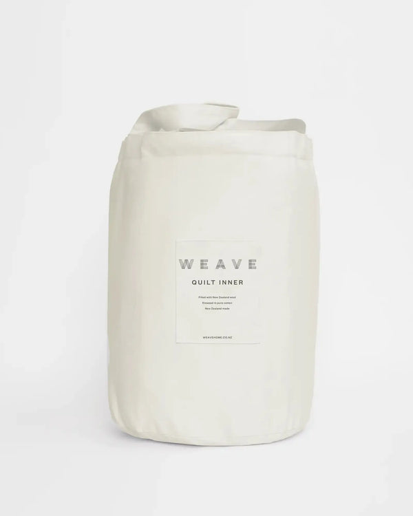 A quilt or duvet inner made from 100% New Zealand wool, by Weave Home nz, seen packaged in cotton bag