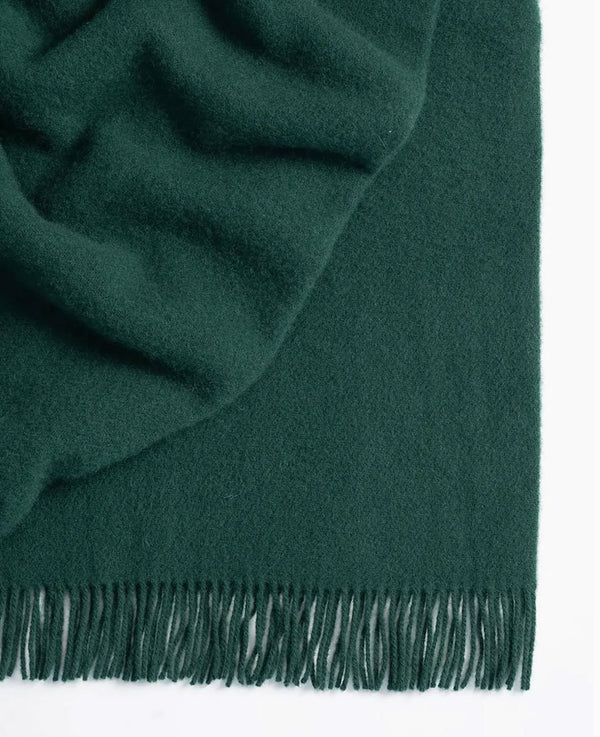 Weave Home wool throw blanket in colour 'forest' - a rich, dark green 