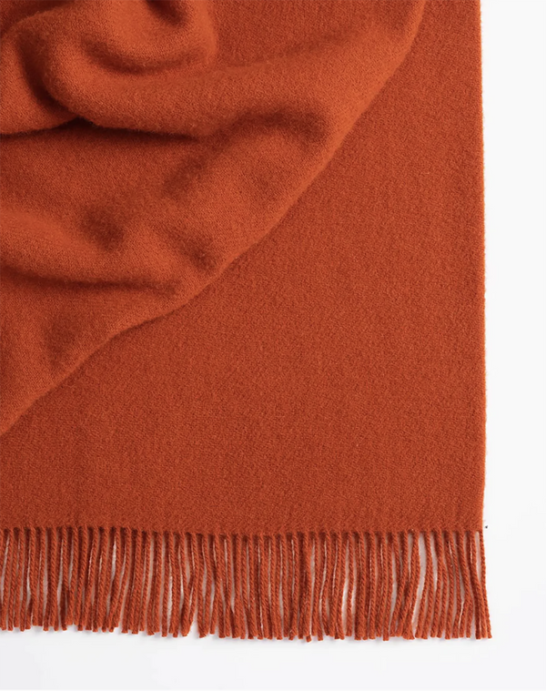Weave Home wool throw blanket in colour 'umber' - a vibrant red