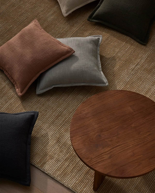 Weave Home Beige rug with table and cushions in a stylish lounge