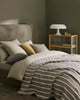 Designer cushions in a stylish bedrooom setting