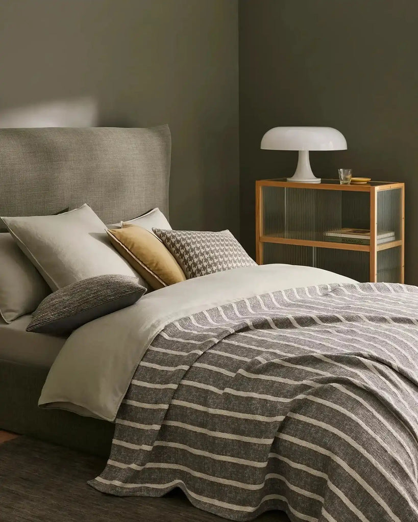 Designer cushions in a stylish bedrooom setting