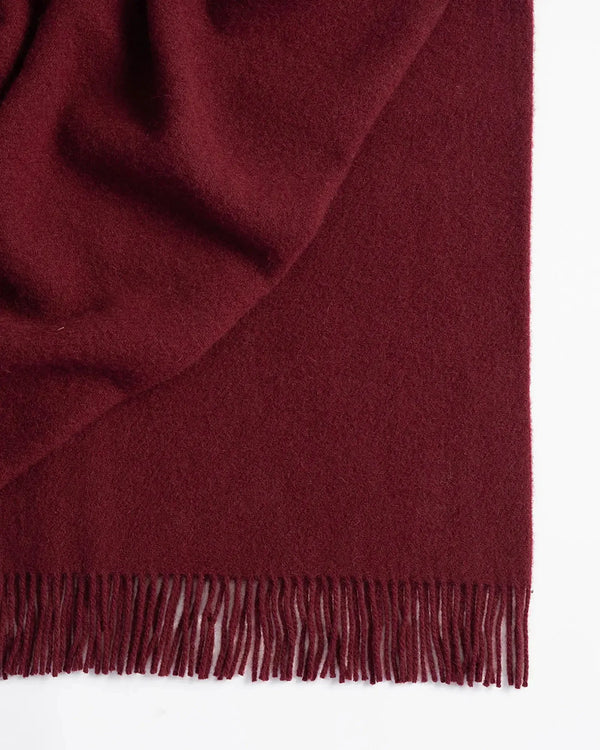 Weave Home wool throw blanket in colour 'rhubarb' - a rich deep red