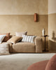 A modern living room in warm brown on-trend tones, featuring cushions by Weave Home nz