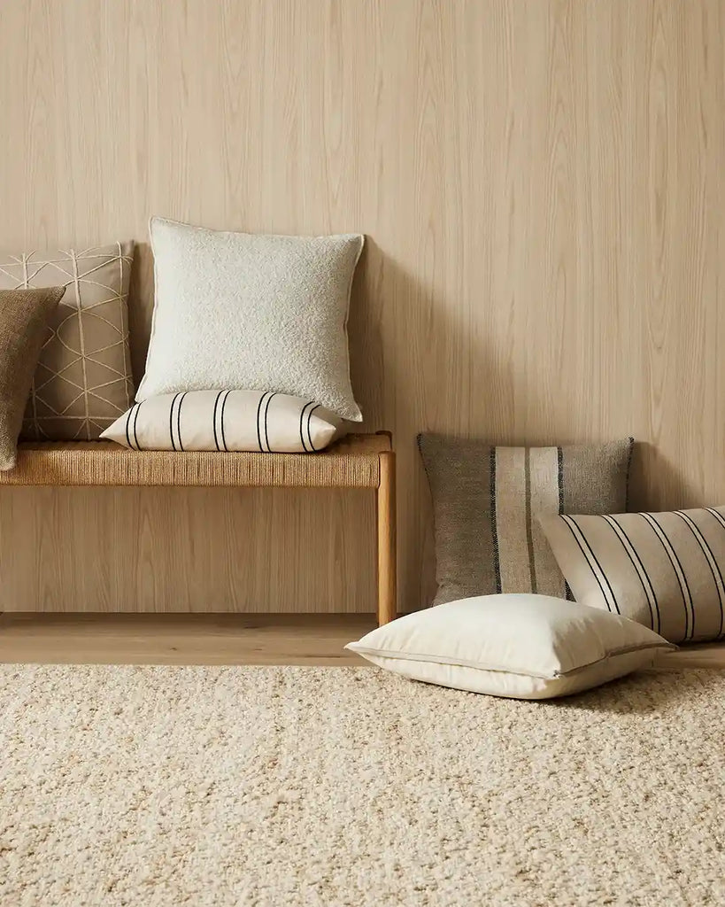 A selection of cushions and the Henley wool boucle rug, part of the Santa Pollini collection