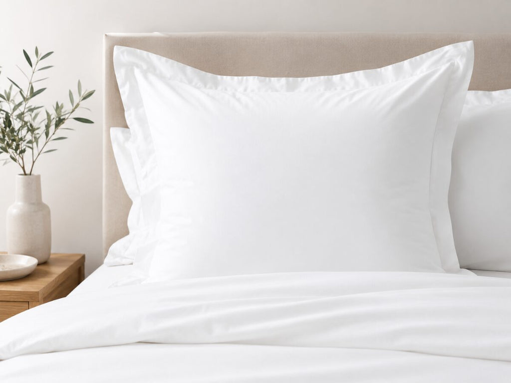 Crisp white 100% cotton Euro pillowcase with flange on a nicely made bed