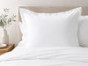 Crisp white 100% cotton Euro pillowcase with flange on a nicely made bed
