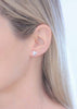 Wild kawakawa leaf earrings in silver, worn for a model to show scale