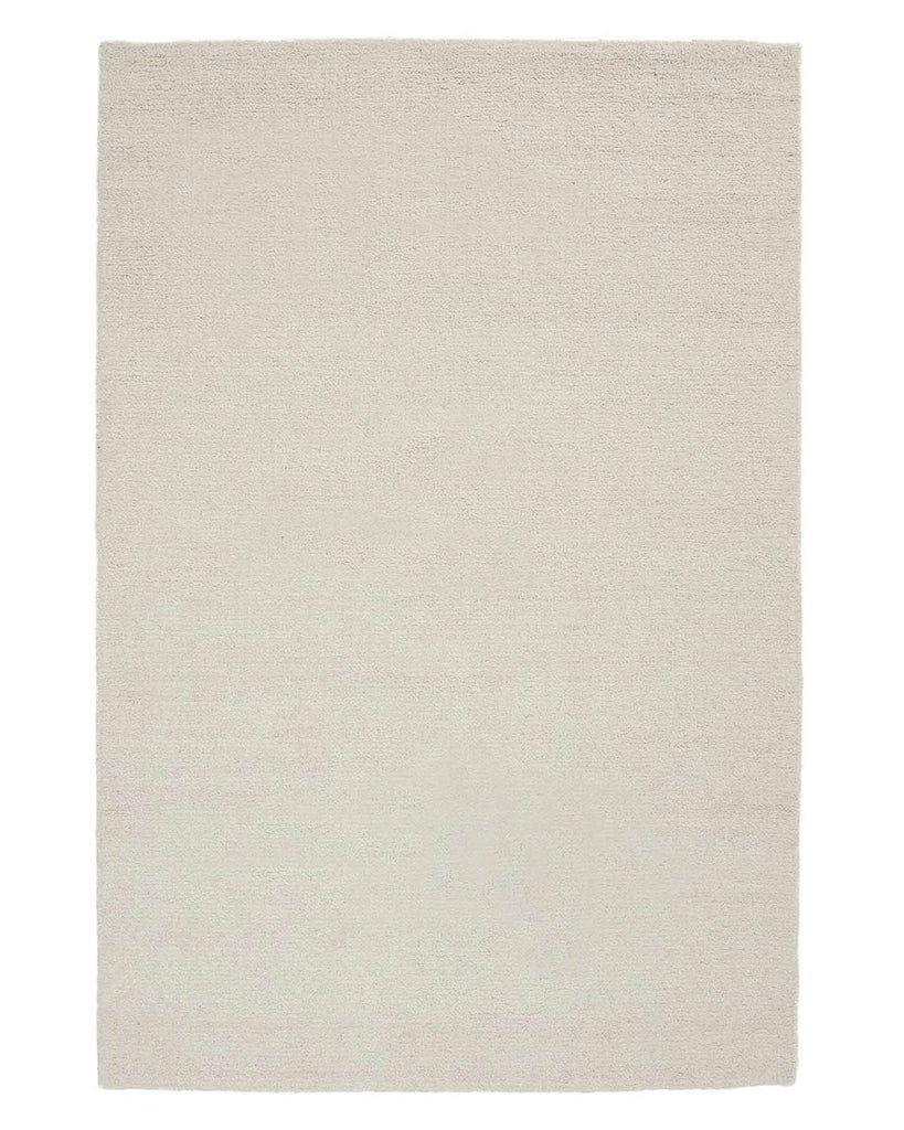 A full image of a loop pile wool blend floor rug in cream. 