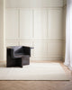 A sitting room in shades of white and cream with a textural linear patterned floor rug in soft cream, 100% wool. By Baya. 