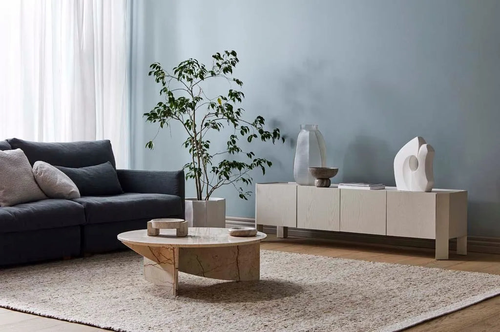 A textural woolen rug, in shades of honey brown and light beige, with subtle colour shifts by Soren Liv NZ and Globe West, in a stylish modern living room 
