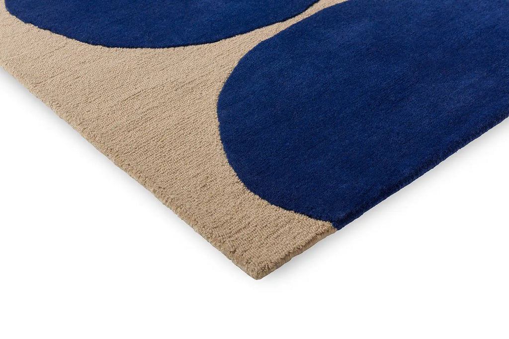 Close up corner view of the Marimekko Isot Kivet blue wool rug showing cut and loop pile design