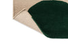Close up corner shot of the The Marimekko Isot Kivet rug in a rich green and cream showing folded corner to reveal underneath