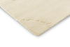 Corner close up of the Marimekko Iso Unikko wool rug in natural white