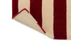 Close up view of the The Marimekko Ralli wool floor rug with corner folded up to reveal underneath