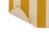 Close up of the Marimekko Ralli Yellow, striped wool floor rug with corner folded to reveal underneath