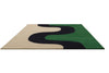 Perspective view of the Marimekko Seireeni green floor rug featuring an organic curve design in green, black and cream