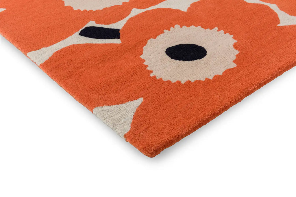 Corner close up of the Marimekko Unikko wool floor rug in orange-red