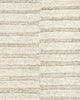 A close up image of the weave of this handtufted rug, made with cut and looped pile, in a sophisticated cream colour. 
