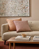 Baya Alden linen cotton blend cushion in Clay, closer view styled on a sofa with a striped cushion
