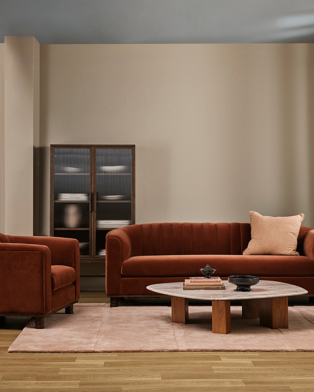 Baya Alden linen cotton blend cushion in Clay, styled on a rust velvet sofa