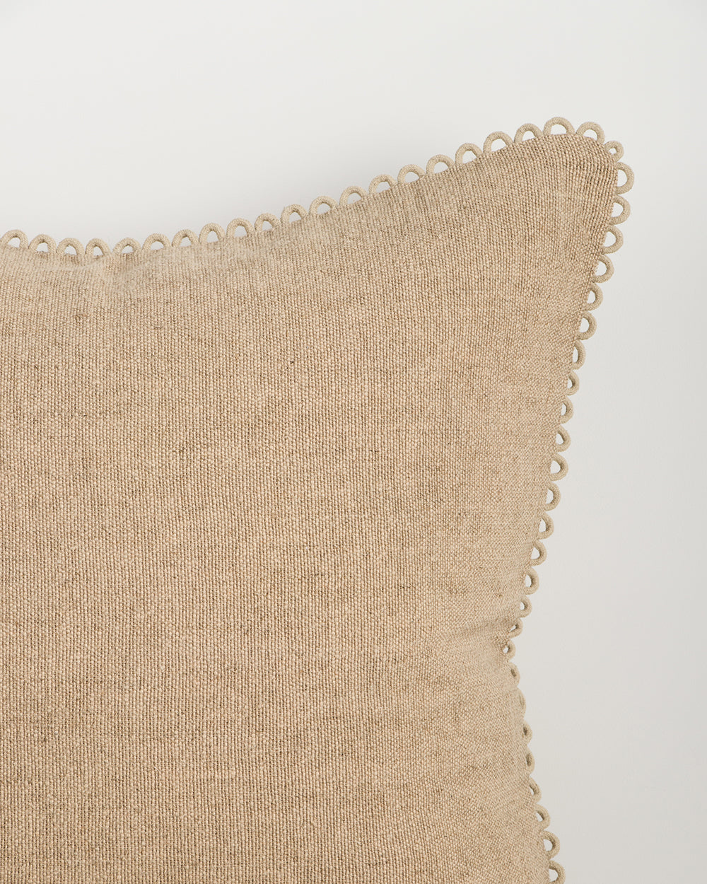Baya Alden linen cotton blend cushion in Oat, close view of the loop-edge trim