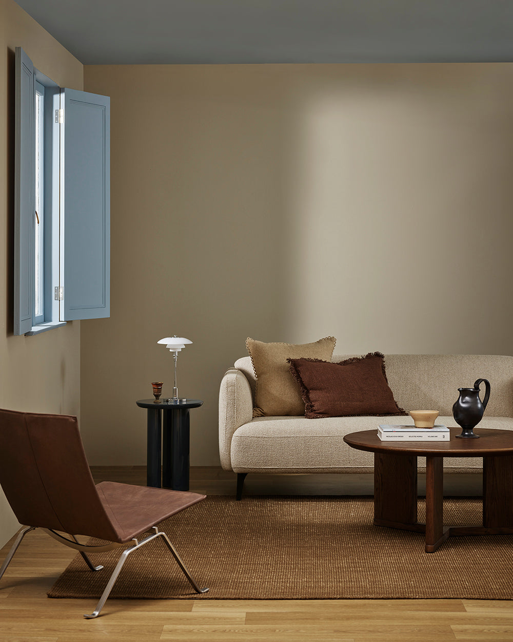 Baya Alden linen cotton blend cushion in Oat, styled on a sofa in a living room