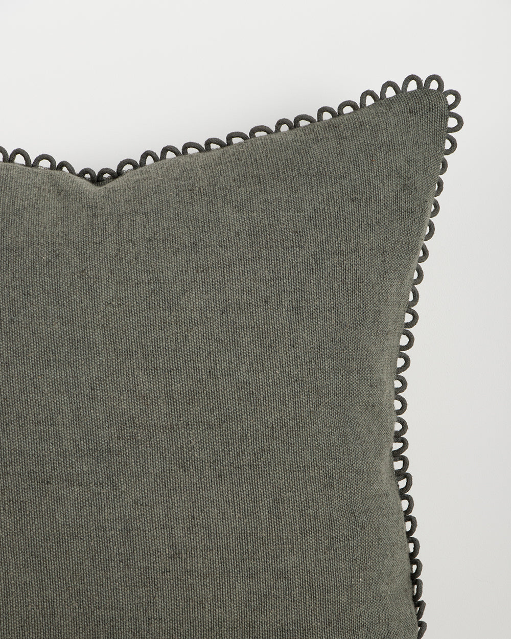 Baya Alden linen cotton blend cushion in Sage, close view of the loop-edge trim