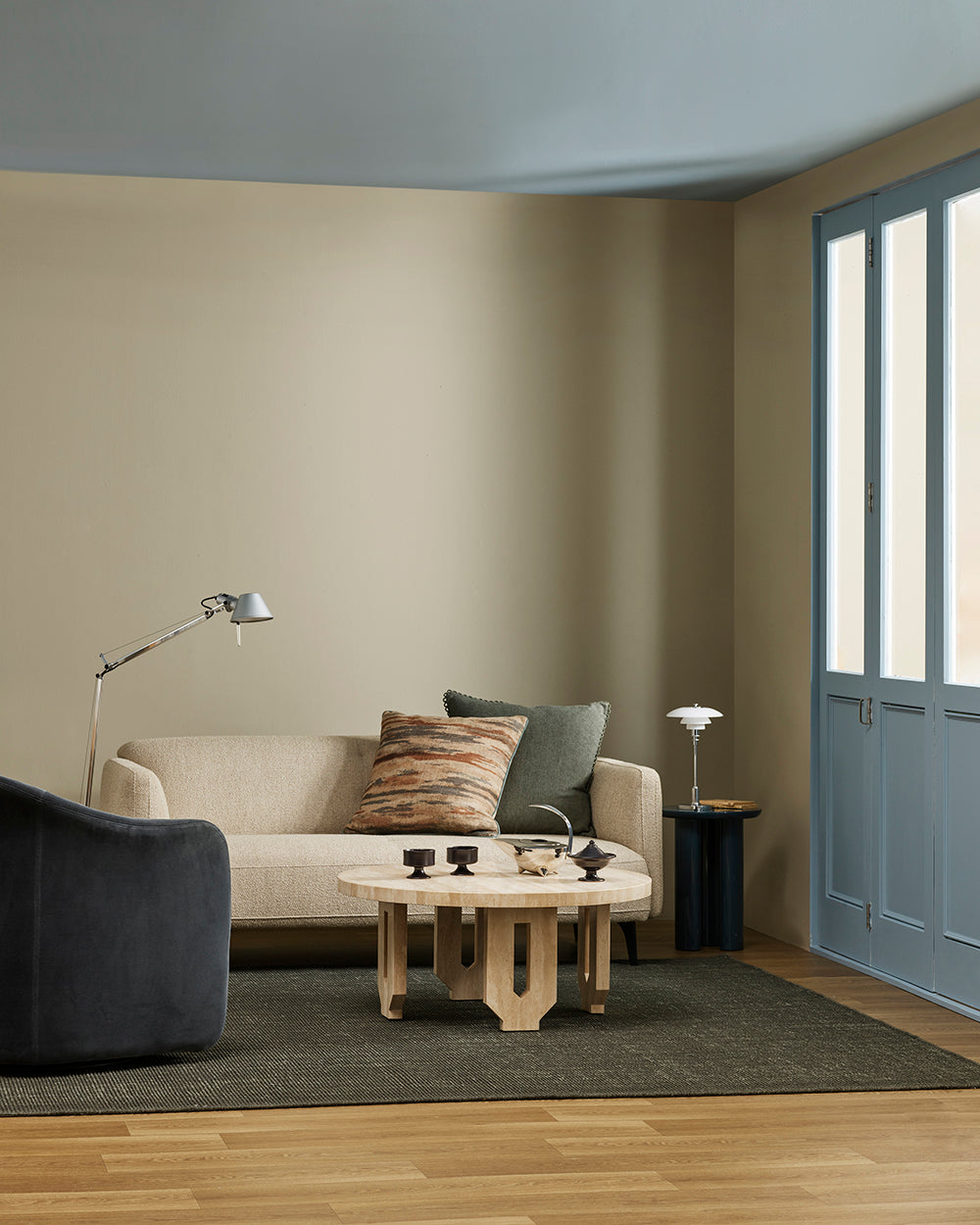 Baya Alden linen cotton blend cushion in Sage, styled on a sofa in a living room with a patterned lumbar cushion