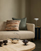 Baya Alden linen cotton blend cushion in Sage, styled on a sofa with a patterned lumbar cushion