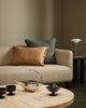 Baya Alden linen cotton blend cushion in Sage, styled on a sofa with a tan fringed lumbar cushion