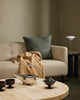Baya Alden linen cotton blend cushion in Sage, styled on a sofa with a tan throw