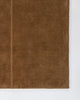 Baya Bastion NZ wool floor rug in Hazelnut, close view of a corner showing the pile and a fine lengthwise line.