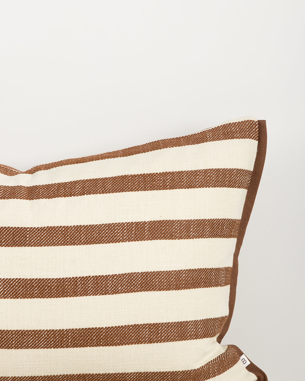 Baya Calden cotton lumbar cushion in Chestnut, close view of the flanged edge and jacquard stripe