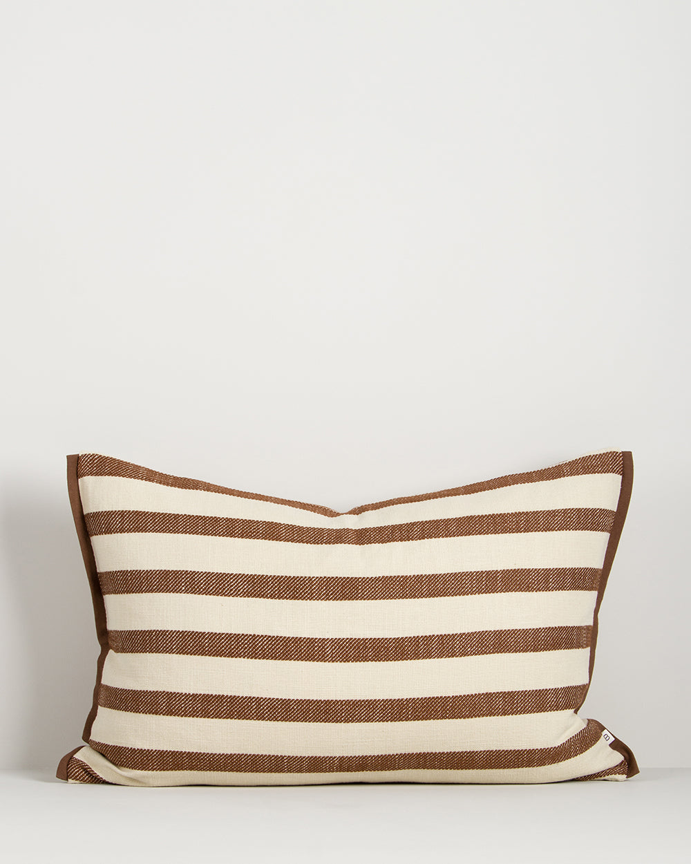 Baya Calden cotton lumbar cushion in Chestnut on a plain background