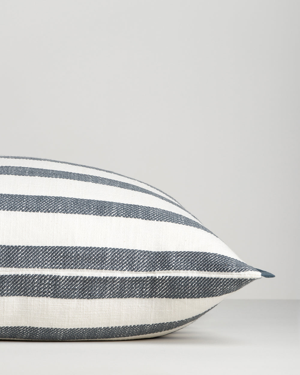 Baya Calden cotton lumbar cushion in Cloudburst, side view showing its shape and edge finish