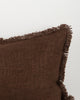 Close detail of the Dover Chocolate lumbar cushion's hand-finished fringe trim and woven texture