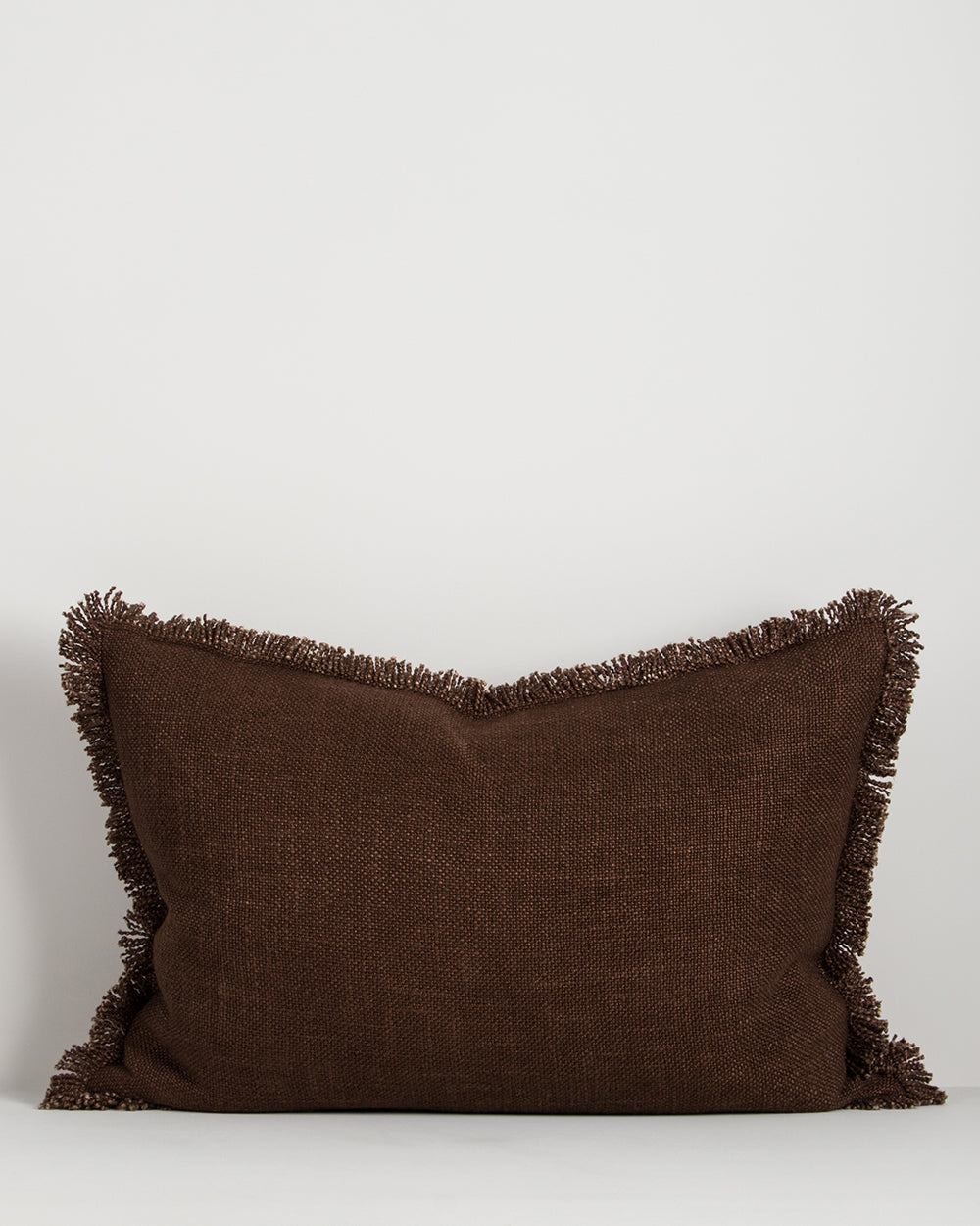 Baya Dover linen blend lumbar cushion in Chocolate, 40 x 60cm, front view on a plain background showing the fringed edge and textured weave
