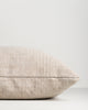 Side profile of the Baya Dune outdoor cushion in Almond, lying flat, showing the piped seam edge